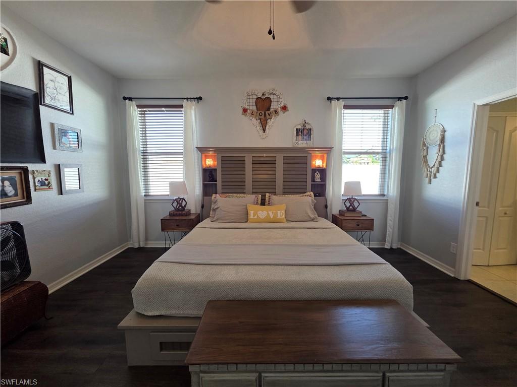 Bedroom with dark wood-style floors and ceiling fan