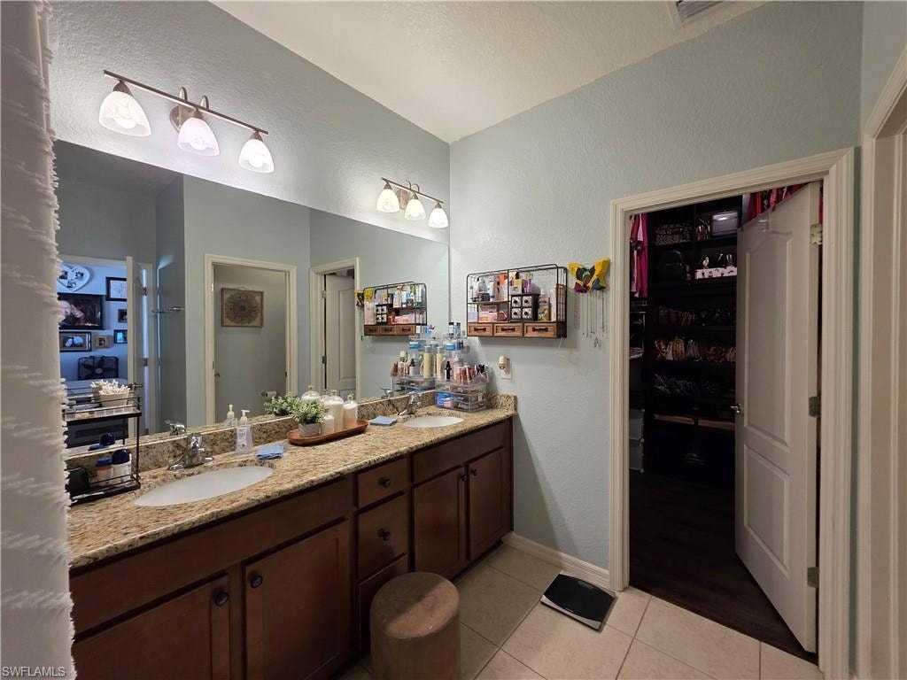Bathroom with double vanity, and entrance to the massive walk in closet