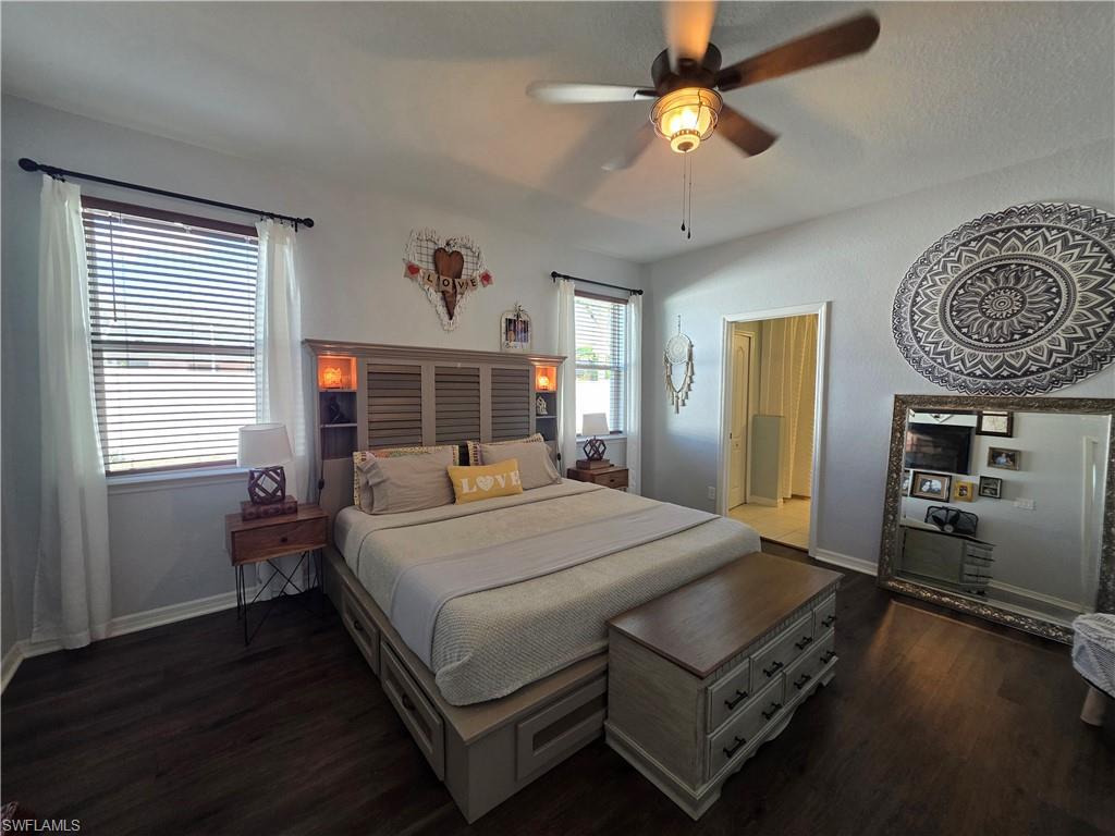 Bedroom with dark wood-style floors and ceiling fan