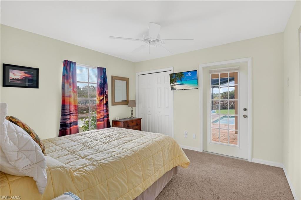 Bedroom featuring light colored carpet, a closet, and ceiling fan