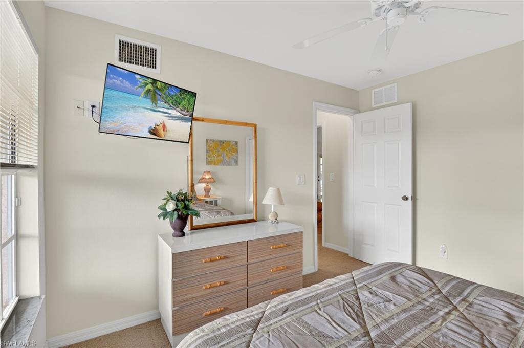 Bedroom with light colored carpet and ceiling fan