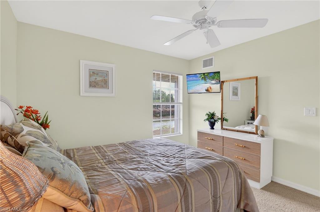 Bedroom with light carpet and ceiling fan