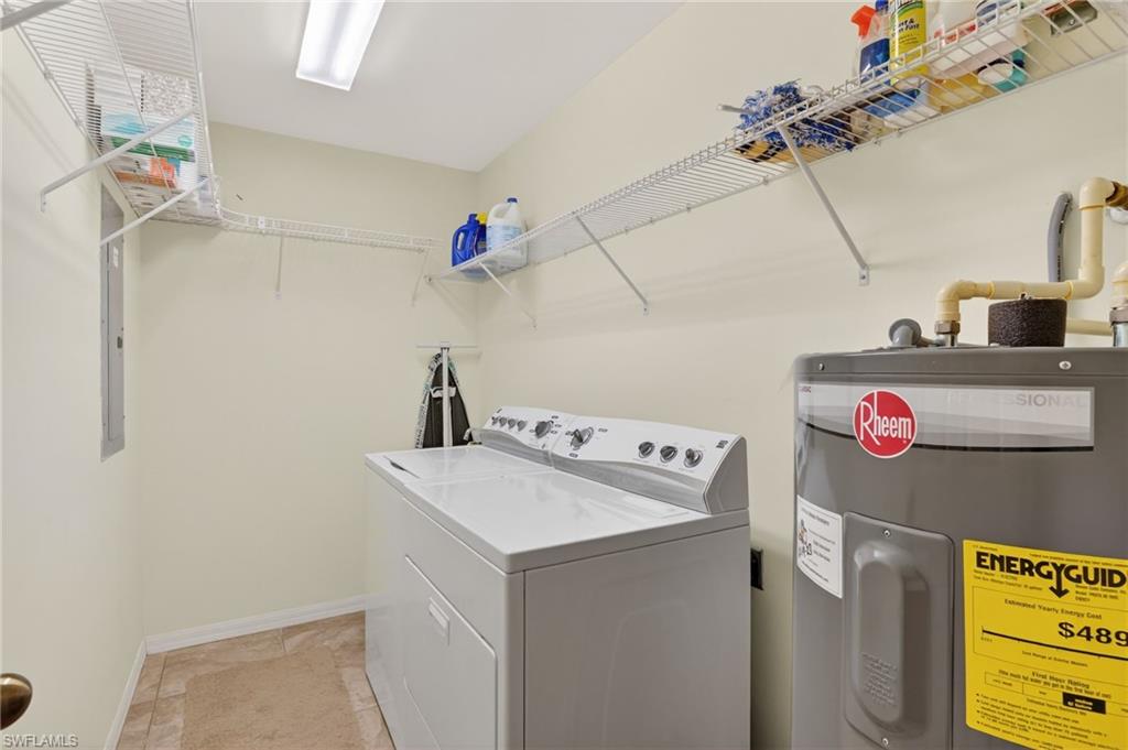 Laundry room featuring electric water heater and washing machine and clothes dryer