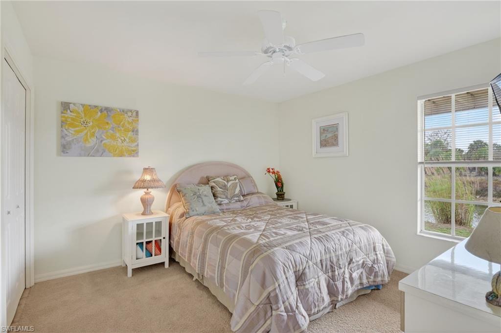 Bedroom featuring a closet, light carpet, and a ceiling fan
