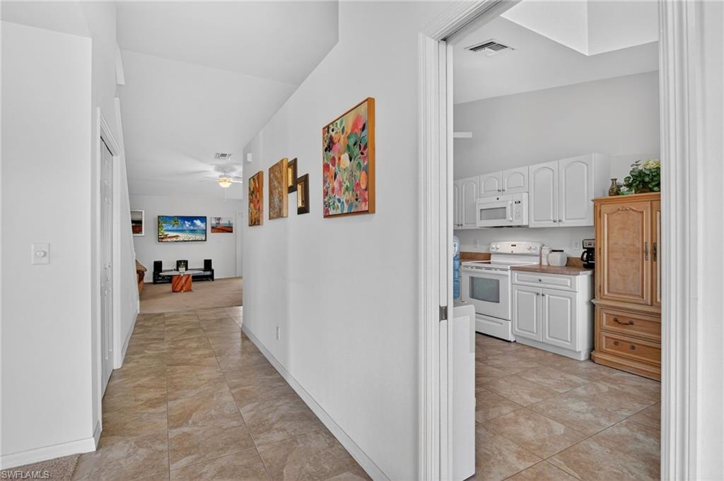 Corridor featuring light tile patterned flooring