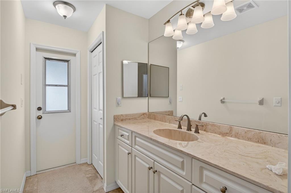 Bathroom with vanity and baseboards
