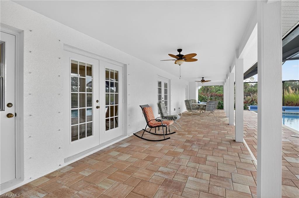 View of patio / terrace with french doors, an outdoor pool, outdoor dining space, and ceiling fan