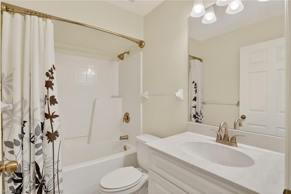 Bathroom with vanity and shower / tub combo with curtain