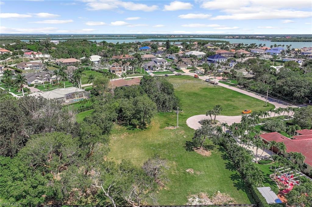 View of property location featuring a large body of water and nearby suburban area