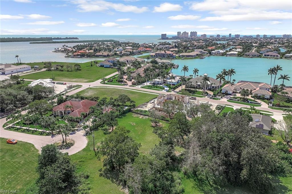 Aerial perspective of suburban area featuring a nearby body of water and city skyline