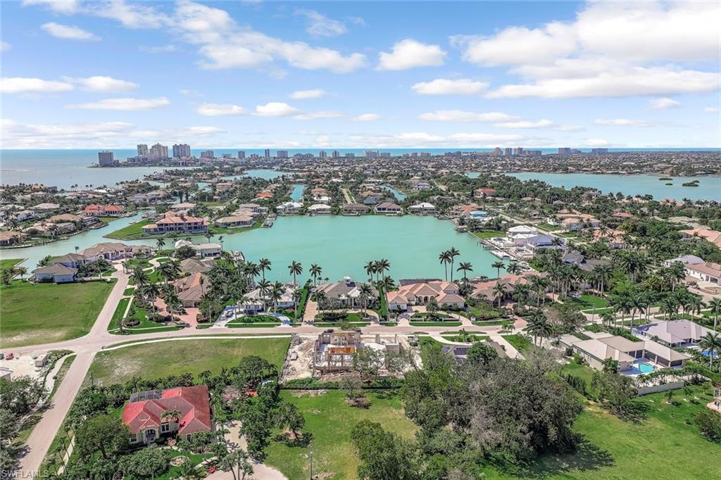 Aerial view of residential area with city skyline and a nearby body of water