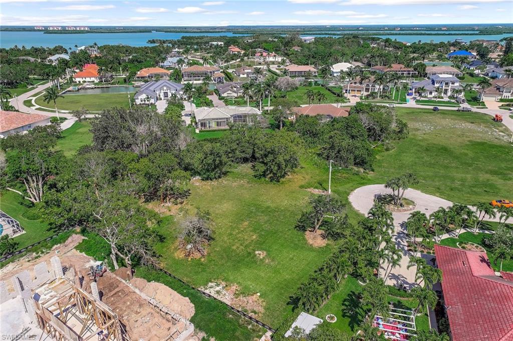 Aerial perspective of suburban area featuring a nearby body of water