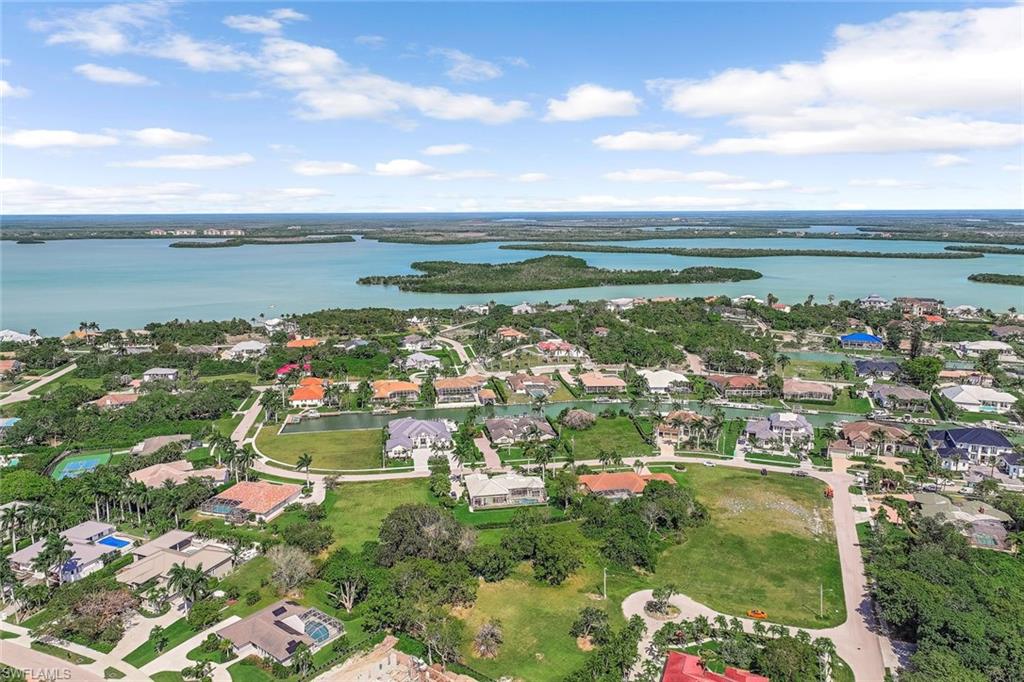 Aerial view of residential area featuring a large body of water