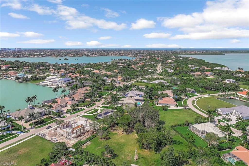 Aerial perspective of suburban area featuring a large body of water