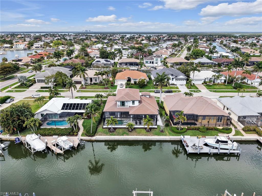 Aerial perspective of suburban area with a large body of water