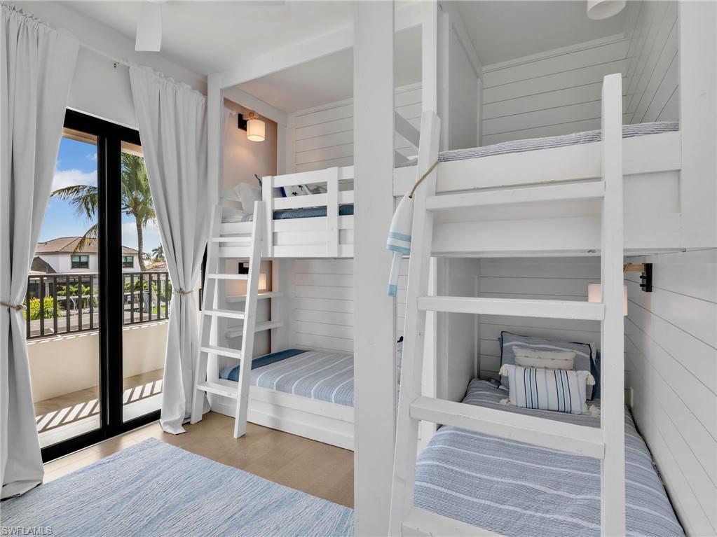 Bedroom with access to exterior and light wood-type flooring