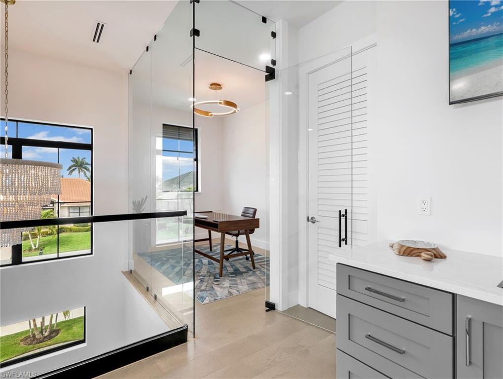 Corridor featuring light wood-style floors and baseboards