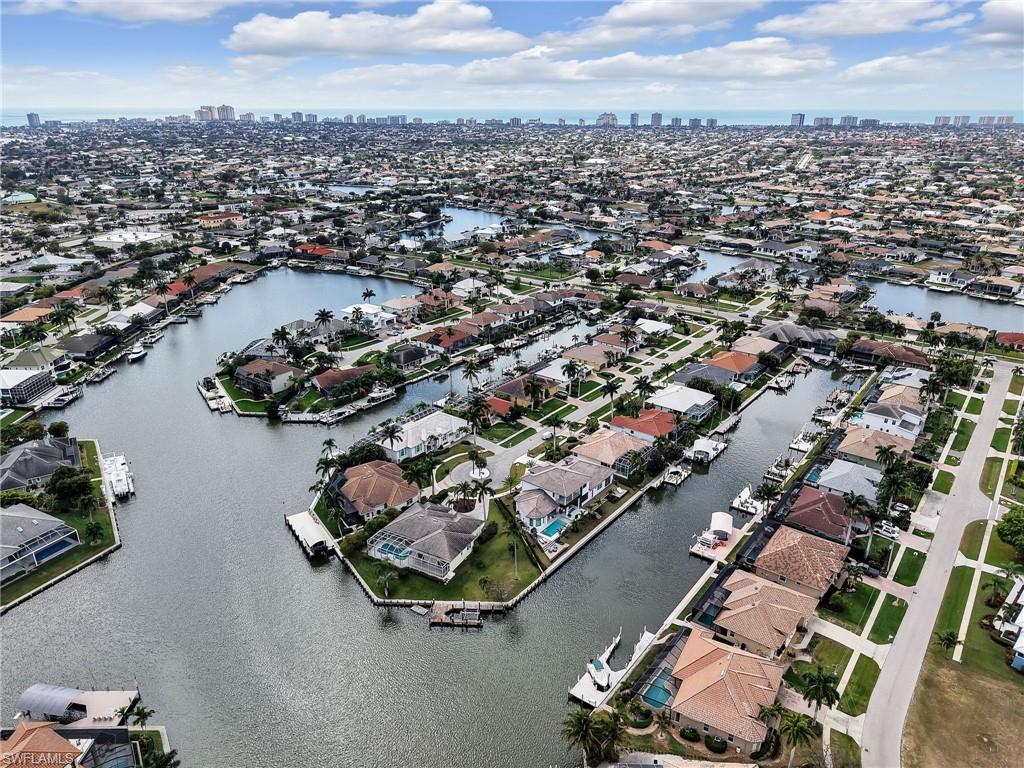 Aerial view of residential area with a nearby body of water and skyline