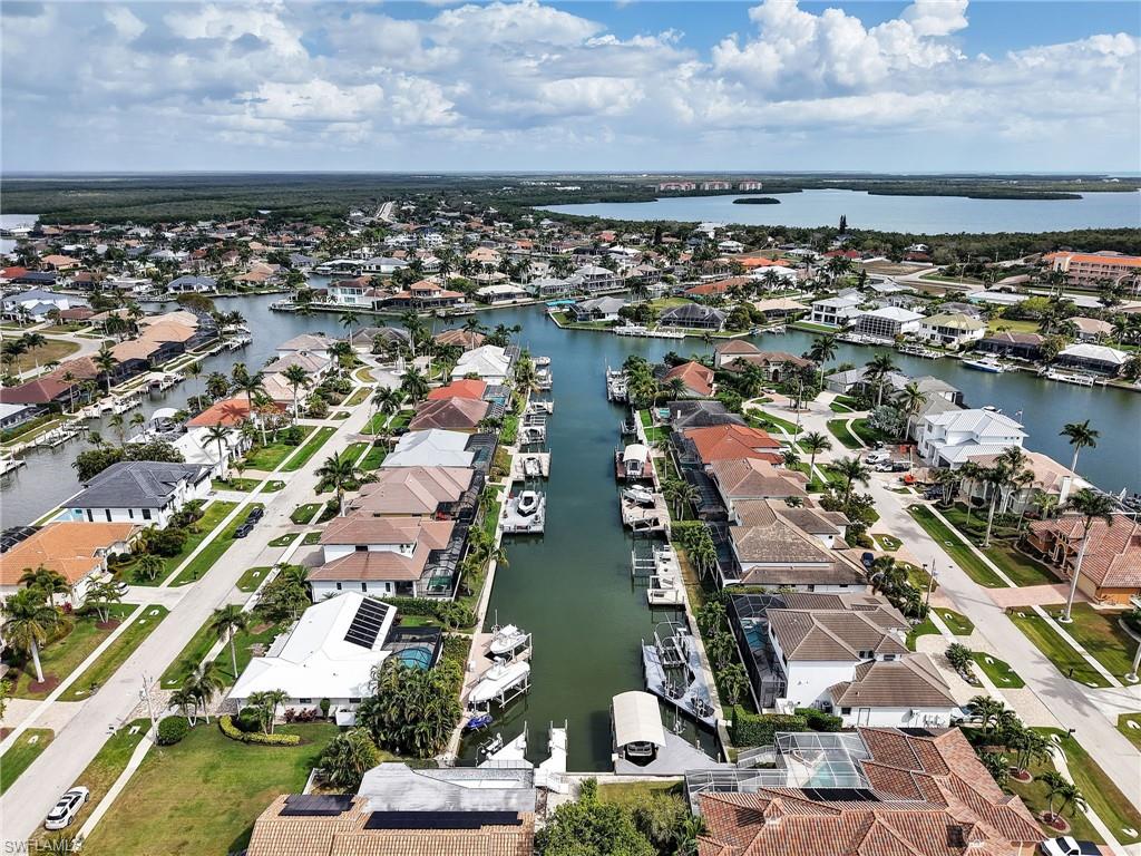 Aerial view of property's location with nearby suburban area and a large body of water