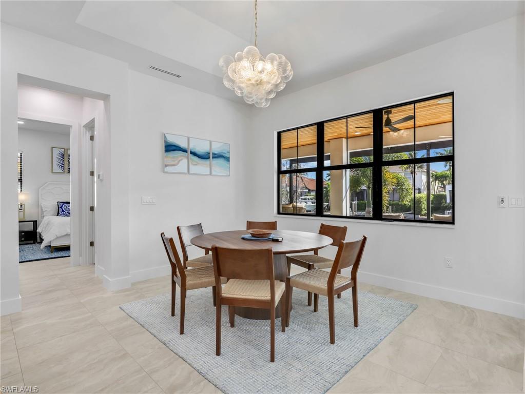 Dining space featuring a chandelier and baseboards