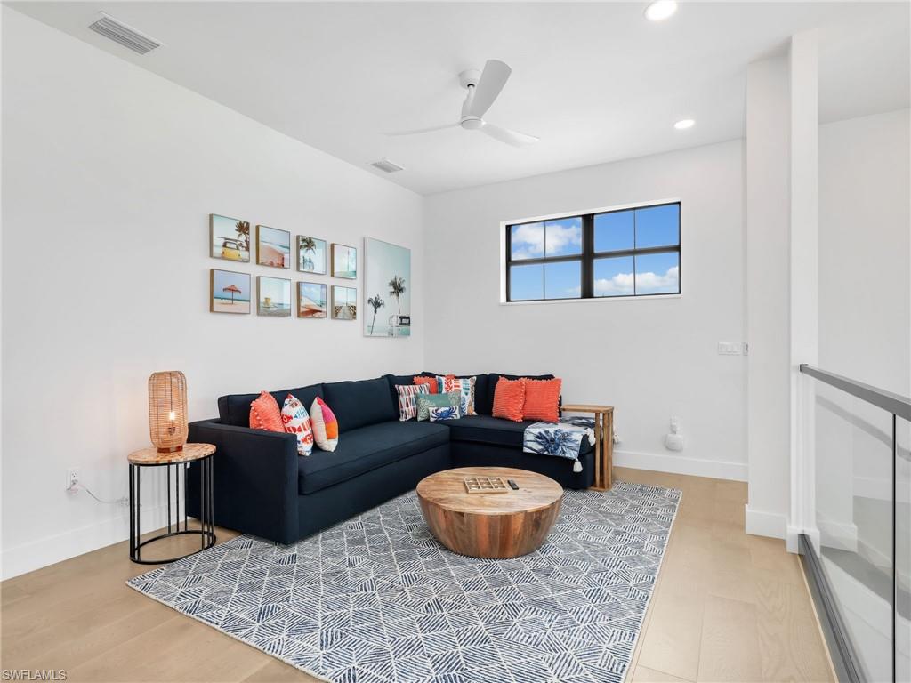 Living area featuring ceiling fan and recessed lighting