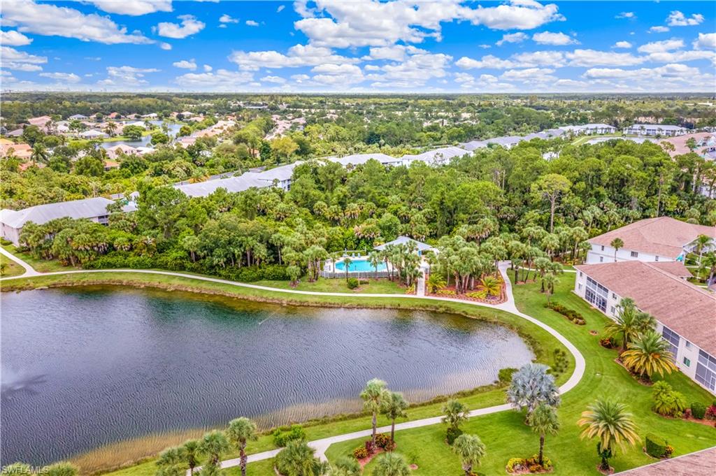 Aerial view of lake, pool, and community