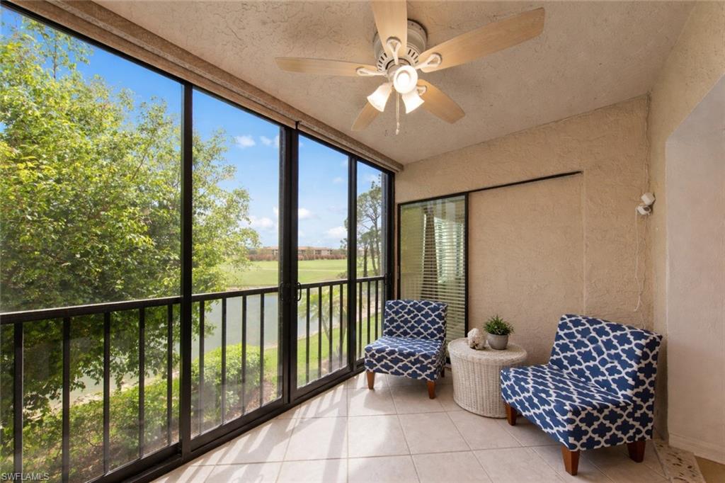 Sunroom featuring ceiling fan and view of golf course