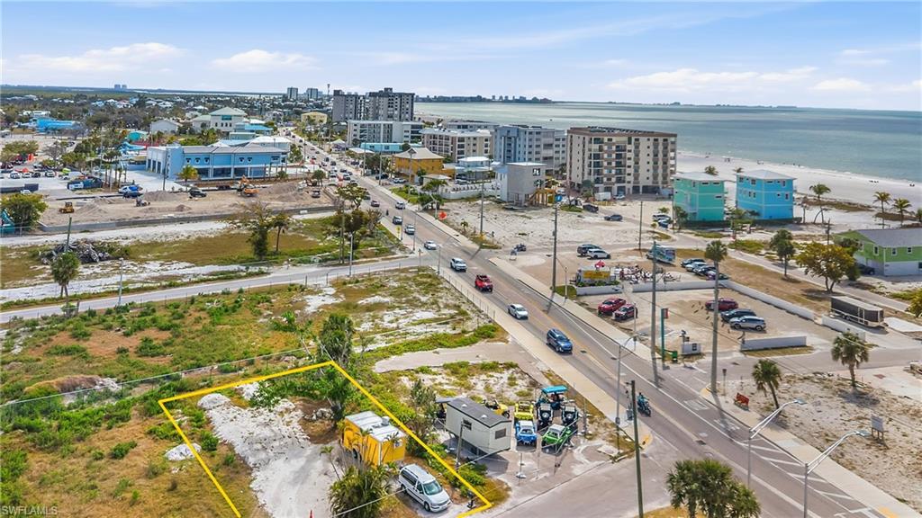 Aerial overview of property's location with a large body of water and property parcel outlined