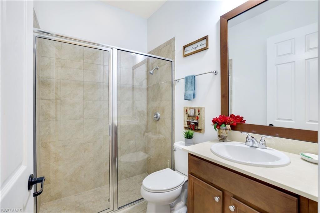 Bathroom featuring vanity and a stall shower
