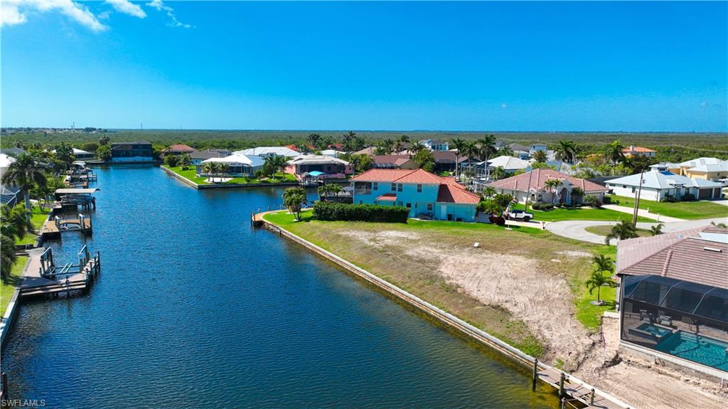 Aerial perspective of suburban area featuring a nearby body of water