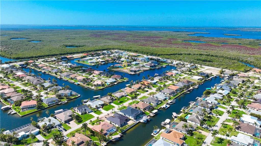 Aerial perspective of suburban area featuring a large body of water