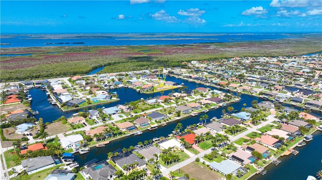 Aerial perspective of suburban area featuring a large body of water