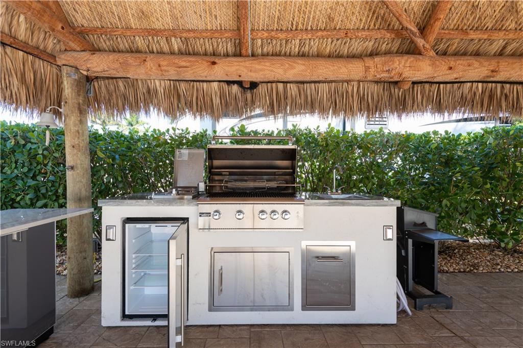 View of patio / terrace featuring exterior kitchen and wine cooler
