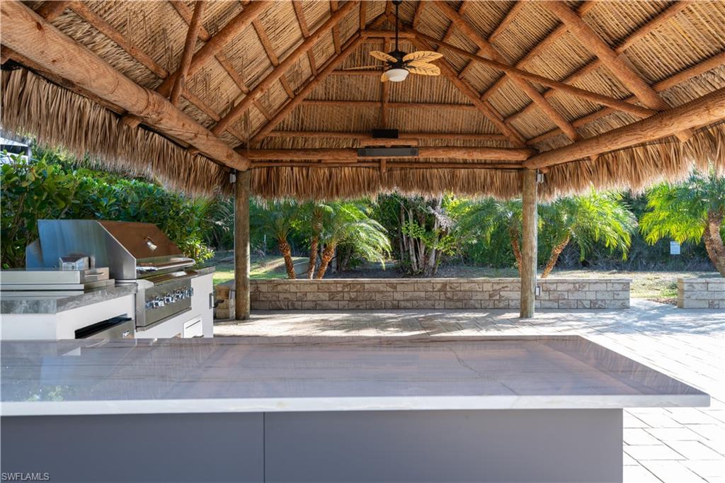 View of patio / terrace with exterior kitchen, a ceiling fan, and a gazebo