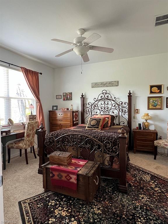 Bedroom with light carpet and ceiling fan