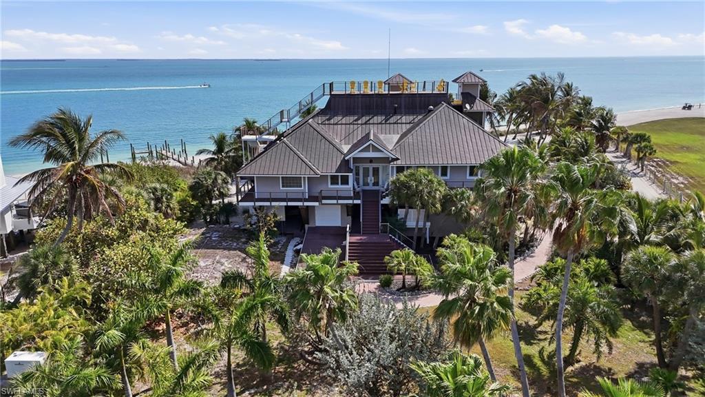 A rare beachfront estate with the ultimate fly-in, boat-in lifestyle. Perfectly positioned along the sugar-sand shoreline of Upper Captiva, this extraordinary property offers panoramic Gulf and bay views, direct beach frontage, and immediate proximity to Salty Approach Airstrip. Ideal for aviation and boating enthusiasts alike, the home is uniquely suited for grass-field capable STOL aircraft and helicopter access, while also offering private dockage for seamless days on the water. Surrounded by turquoise!
