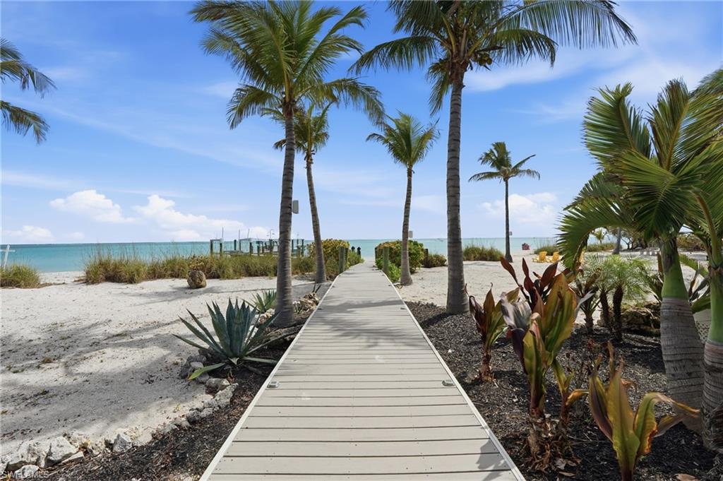 View of community featuring view of water and beach