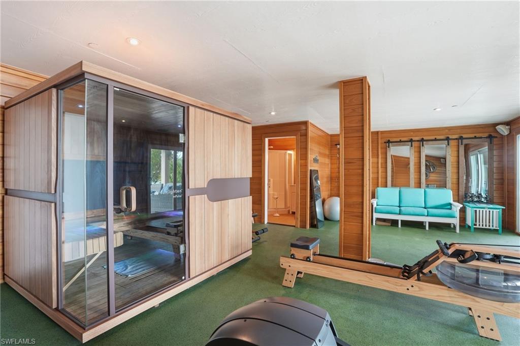 Exercise area featuring a sauna, wooden walls, and carpet floors
