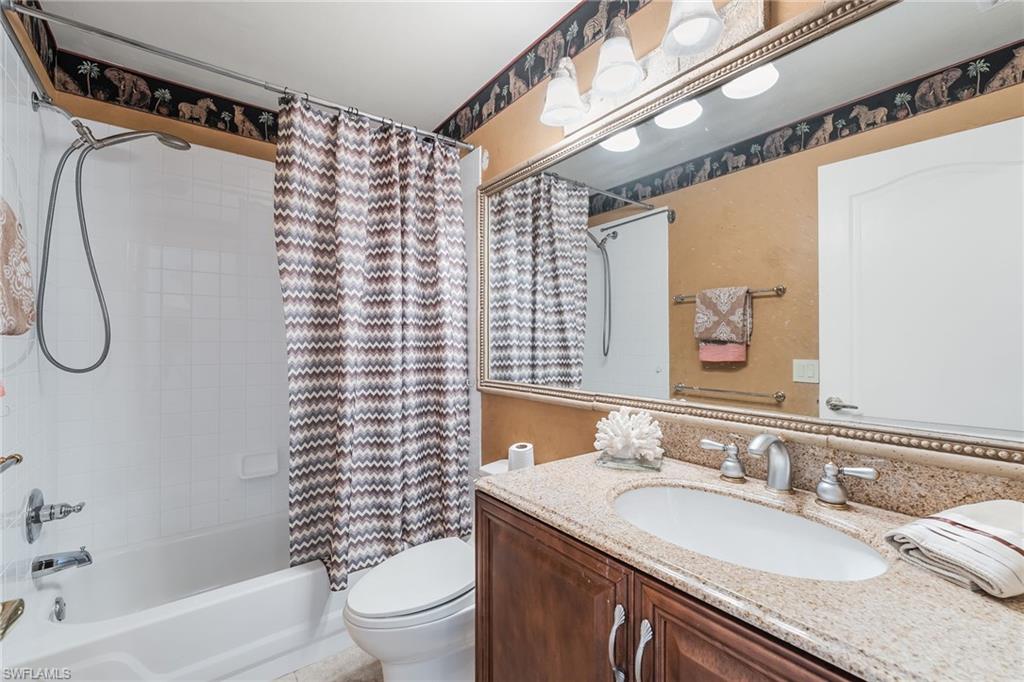 Second Bathroom featuring a vanity with granite-style countertop, integrated sink, and brushed nickel fixtures