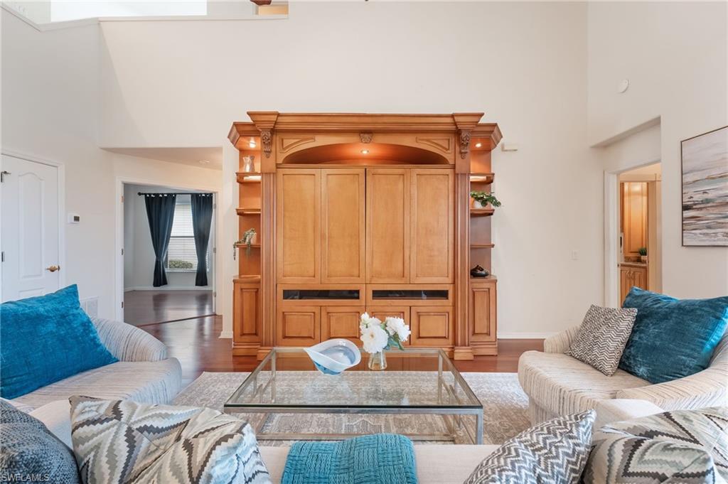 Integrated wood-finish entertainment center with display shelving and built-in lighting