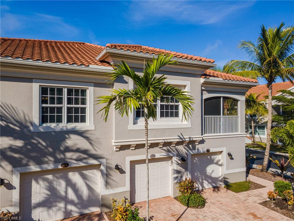 Mediterranean / spanish-style house with stucco siding, a garage, and decorative driveway