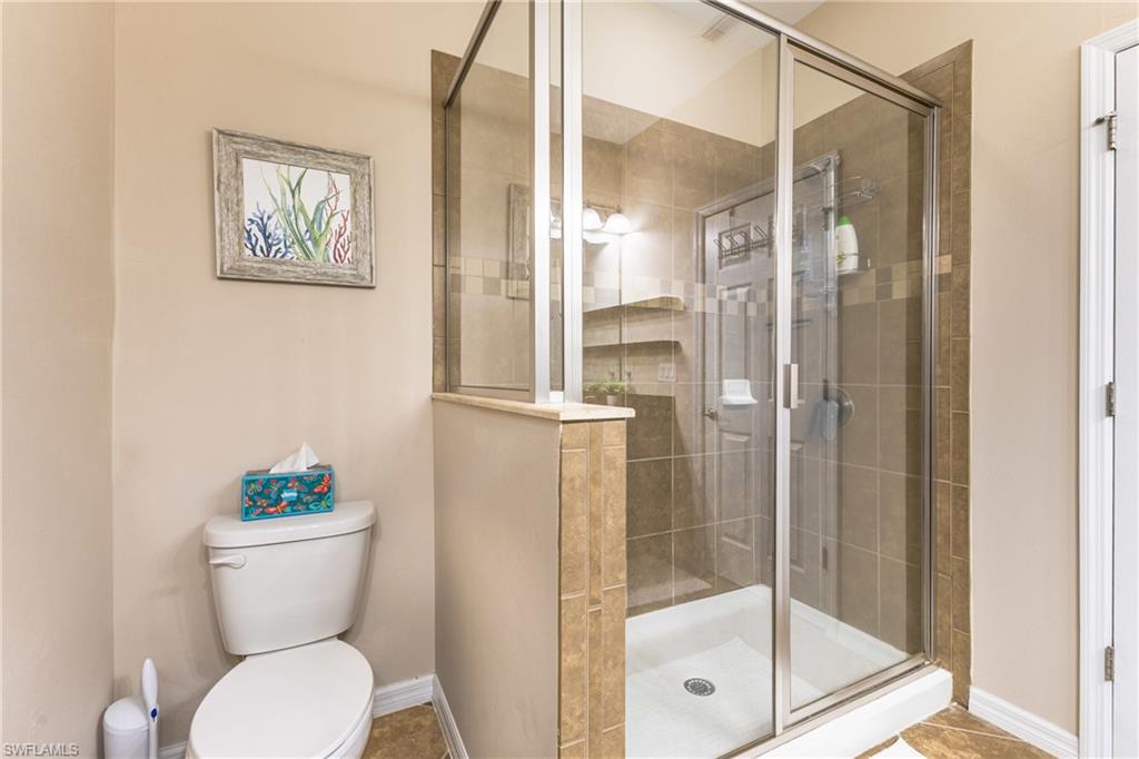 Bathroom featuring toilet and a shower stall
