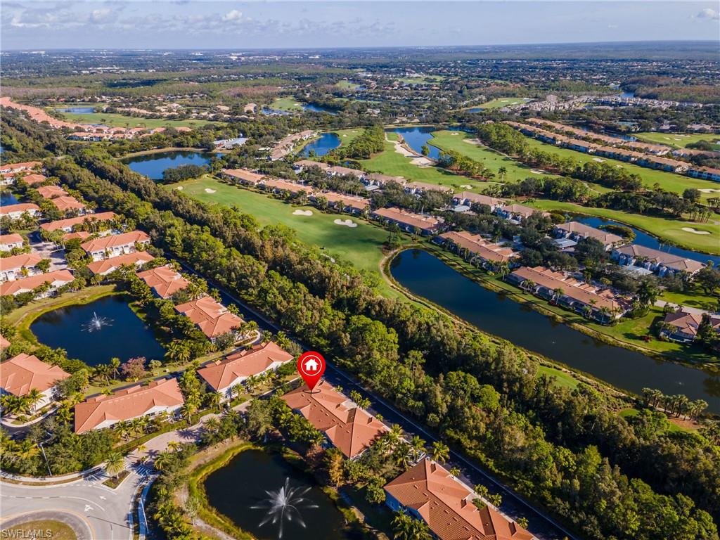Aerial view of property and surrounding area with a large body of water and nearby suburban area