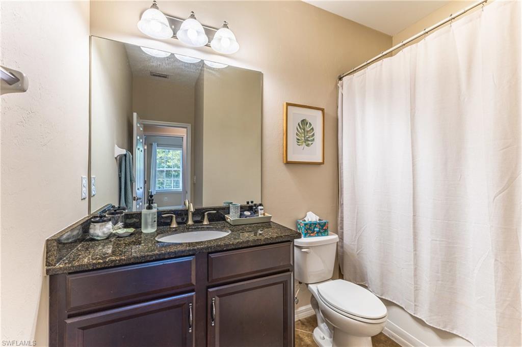 Full bathroom featuring vanity and toilet