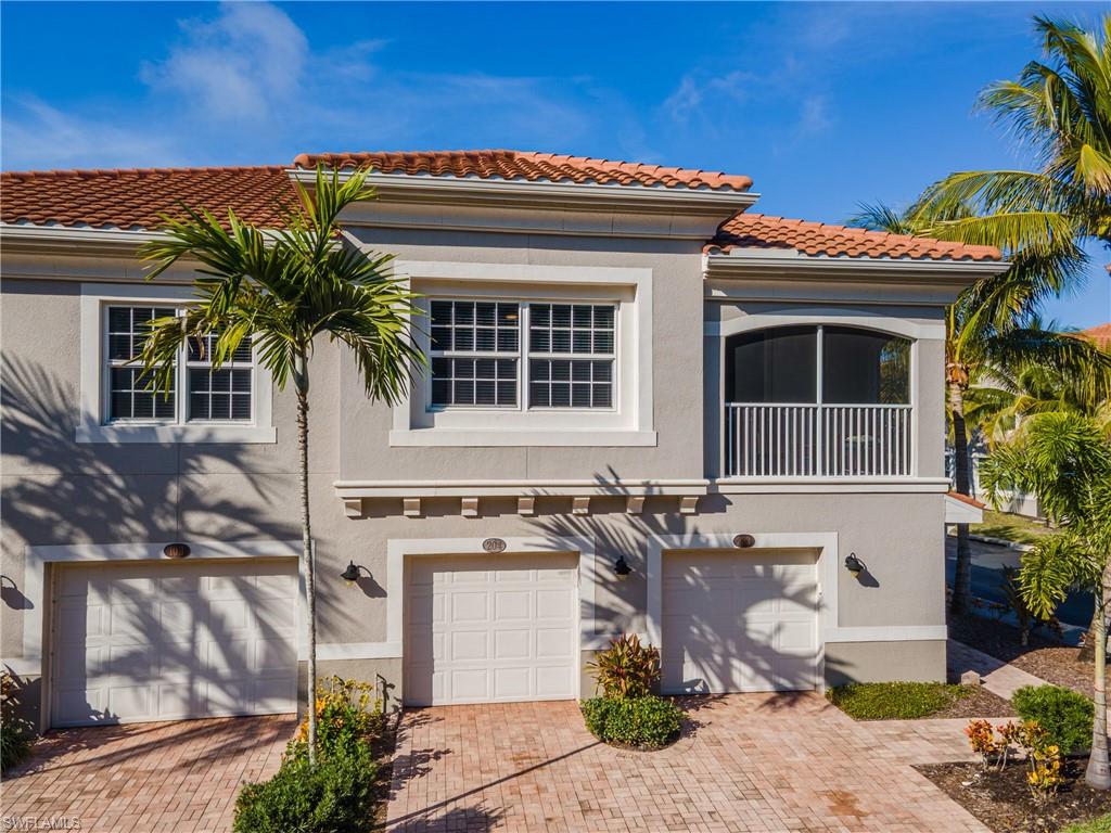 Mediterranean / spanish home featuring stucco siding, a garage, a tile roof, and decorative driveway