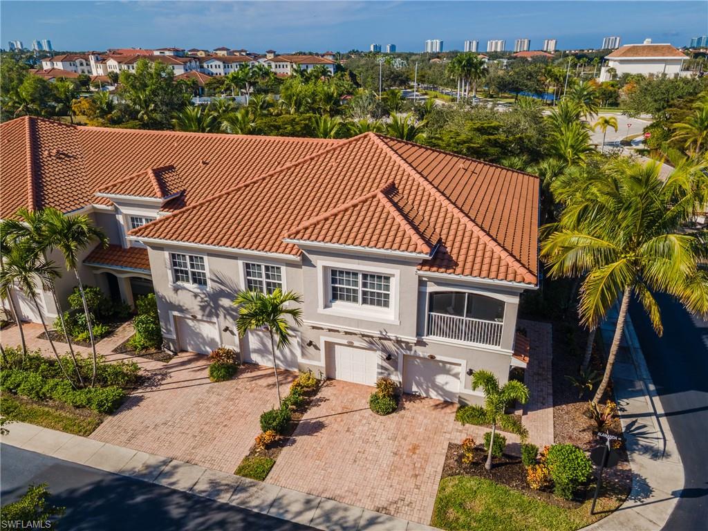Mediterranean / spanish house featuring an attached garage, stucco siding, decorative driveway, and a tiled roof