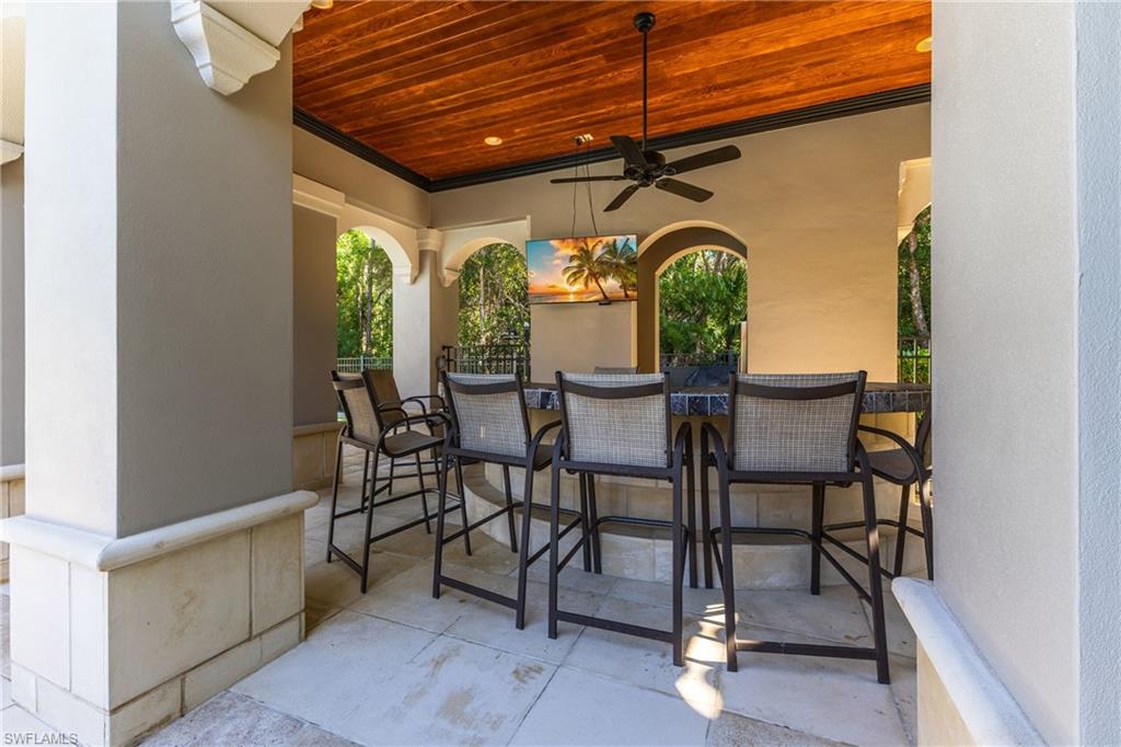 View of patio / terrace with ceiling fan and exterior bar