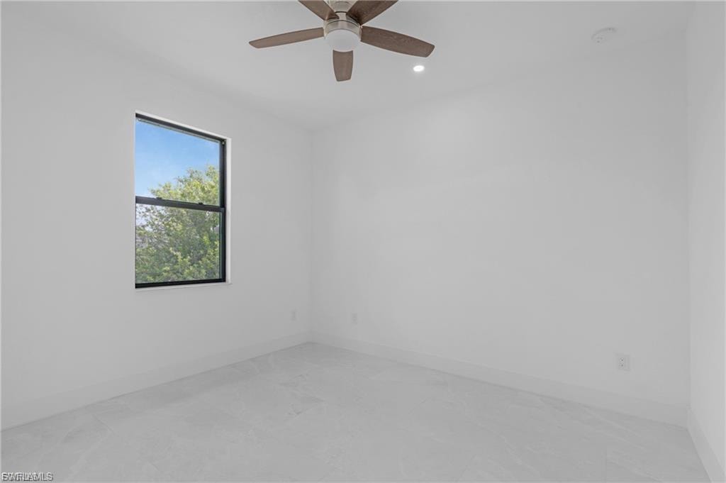 Empty room with ceiling fan and recessed lighting