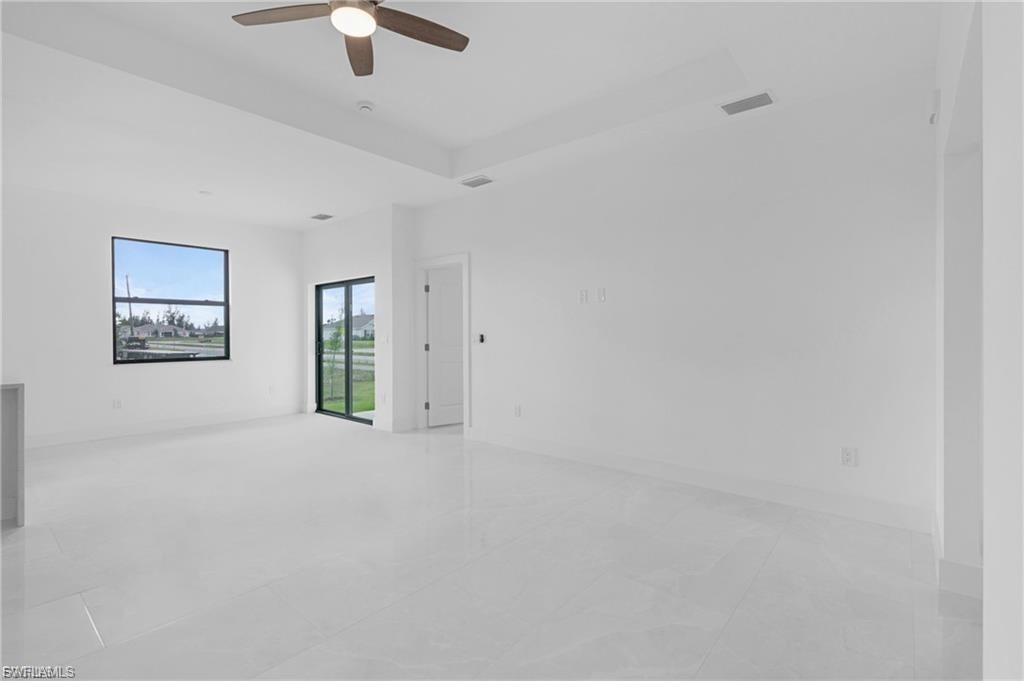 Spare room featuring ceiling fan and a raised ceiling
