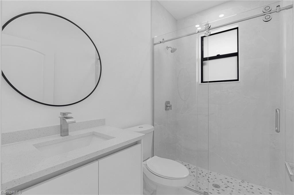 Full bath featuring vanity and a shower stall
